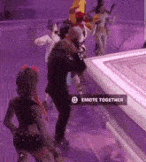 a group of people are dancing on a stage with a sign that says emote together on it .