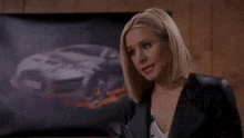 a woman says i said a lot of other nice things in front of a picture of a car