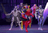 a group of superhero figures standing next to each other on a stage