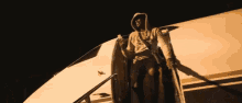 a man in a hoodie is boarding a plane with a gun