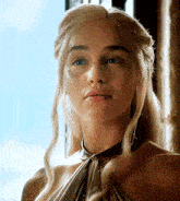 a woman with long blonde hair and a choker around her neck