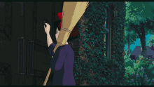 a girl with a red bow on her head is holding a broom