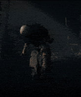 a scarecrow with his arms outstretched is standing in a dark forest