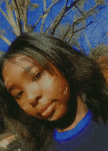 a girl with baby written on her face looks at the camera