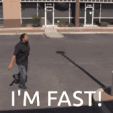 a man walking down a street with the words i 'm fast written on the ground
