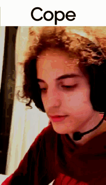 a close up of a person wearing headphones with the word cope written above them