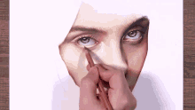 a person is drawing a woman 's face with a pencil which says prismacolor on it