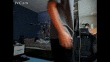 a blurry picture of a person in a bedroom with the word ivcam on the bottom