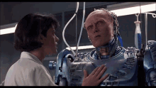 a woman is touching the chest of a robot in a lab