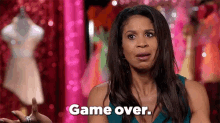 a woman in a blue dress is saying `` game over '' in front of a mannequin .