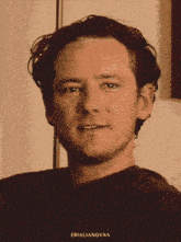 a close up of a man 's face with the name erialianovna on the bottom right