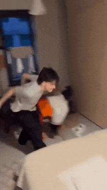 a blurry picture of two people fighting in a bedroom .