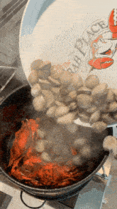 a plate that says the crab place is being poured into a pot of clams