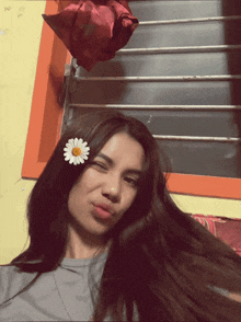 a girl with a daisy in her hair