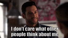 a man with a beard is smiling and saying `` i don 't care what other people think about me ''