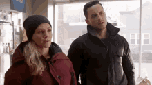 a man and a woman standing next to each other in a store .