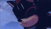a close up of a shadow the hedgehog 's face with a blue sky in the background