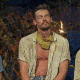 a shirtless man wearing a green bandana around his neck