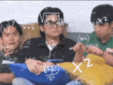 a group of young men are sitting in front of a chalkboard with mathematical equations written on it