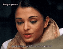 a close up of a woman 's face with a scarf around her neck and a quote .