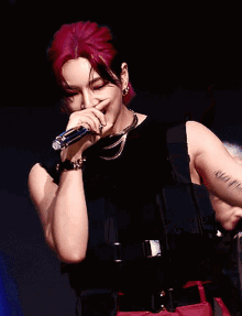a woman with red hair is holding a microphone to her mouth