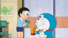 a cartoon character named doraemon is standing next to a boy
