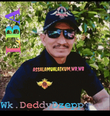 a man wearing sunglasses and a hat with the name wk on the bottom right
