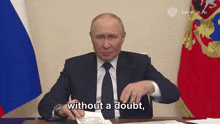 a man in a suit and tie is sitting at a desk and saying without a doubt