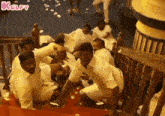 a group of men are kneeling down on the floor .