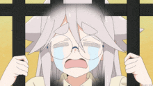 a girl with white hair and glasses is crying behind a fence