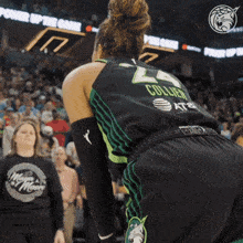 a female basketball player wearing a jersey with the number 24 on it