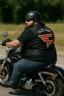 a man on a motorcycle wearing a faze clan vest
