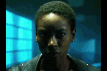 a close up of a woman 's face in a dark room