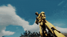 a man in a yellow suit is holding a rifle