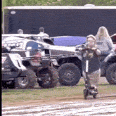 a boy is riding a scooter on a dirt road .