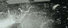 a black and white photo of a person splashing water