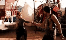 a man and a woman are dancing in the desert .