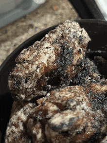 a close up of a piece of food with a black and white crust