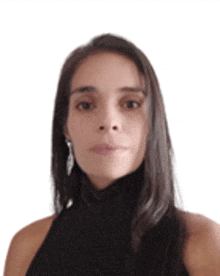 a woman with long hair is wearing a black top and earrings