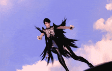 a woman in a black and silver outfit is flying through the air