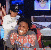 a man wearing a shirt that says n.k.p.p. is laughing