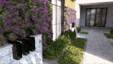 a garden with purple flowers and a fountain
