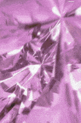 a close up of a purple background with a diamond shaped pattern