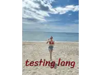 a woman in a bikini stands on a sandy beach with the words testing lang written in red