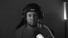 a black and white photo of a man wearing headphones with the words absolute cinema behind him