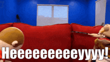 two stuffed animals are sitting on a red couch with the words heeeeeeeeyy written in white letters