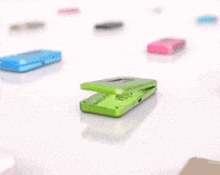 a green phone with a face on it