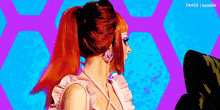a woman with red hair and pink earrings is wearing a pink dress .