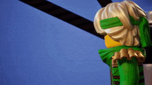 a close up of a lego figure with a green scarf around his head