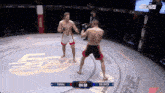 two men are fighting in a ring with the time 04:50 on the screen